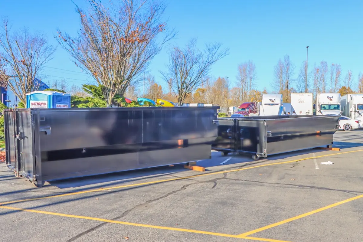 Professional dumpster rental service with roll-off container on residential driveway in Tuckahoe